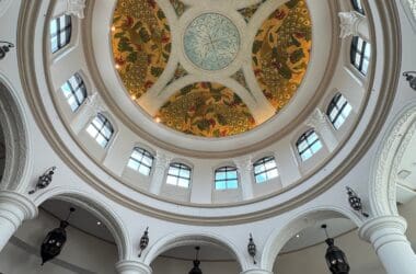 a ceiling with columns and a painted ceiling