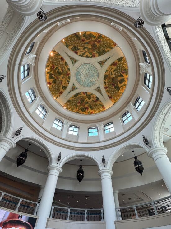 a ceiling with columns and a painted ceiling