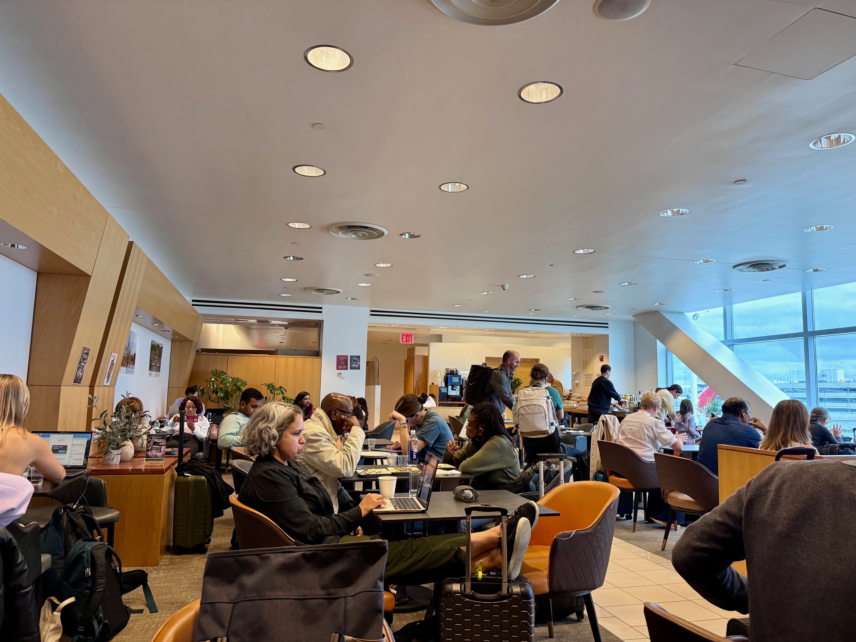 a group of people sitting at tables in the Air India Maharaja Lounge New York