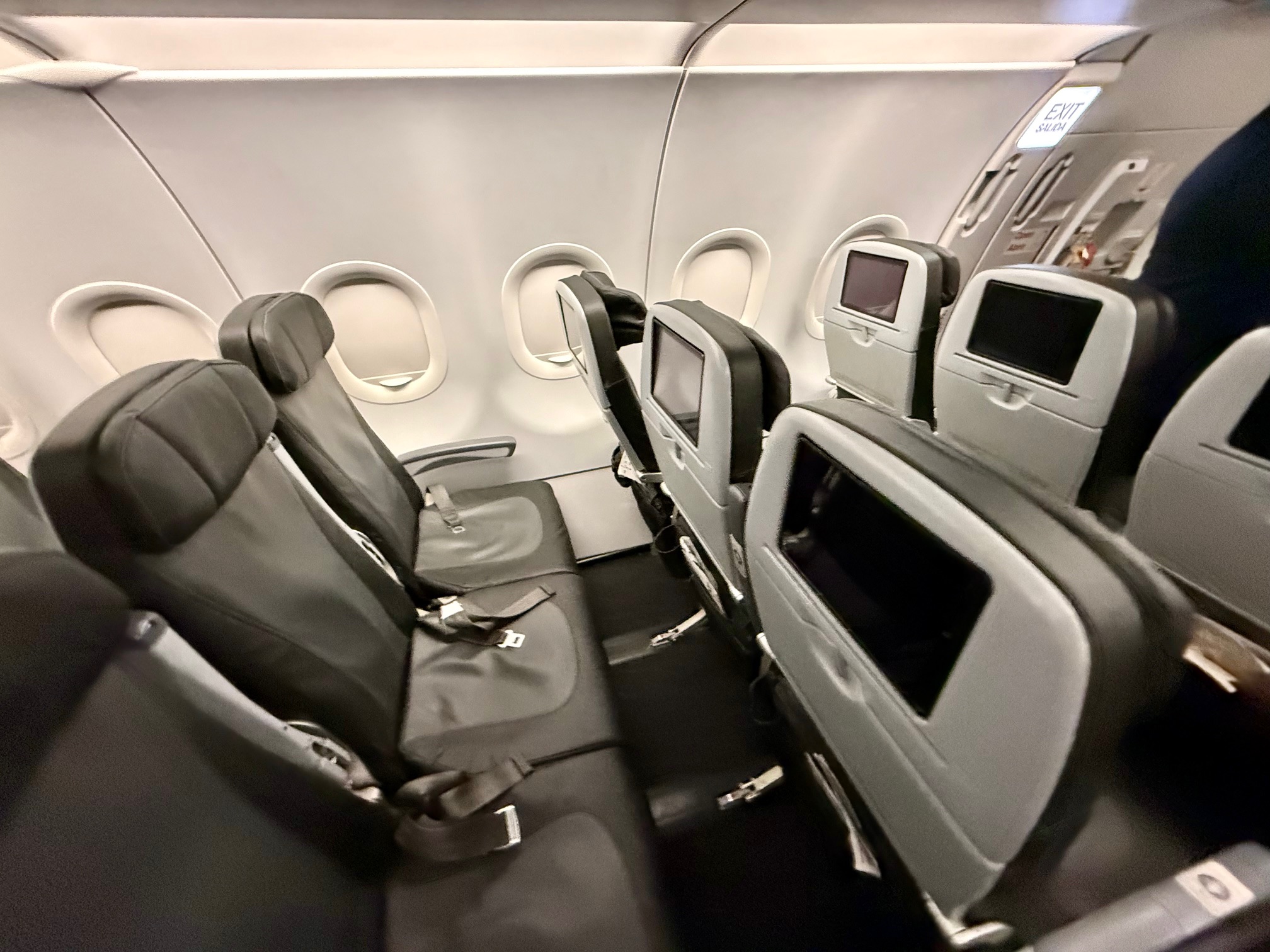 seats in an airplane with a screen on the back on the JetBlue A321 Classic