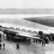 a group of people standing around an airplane