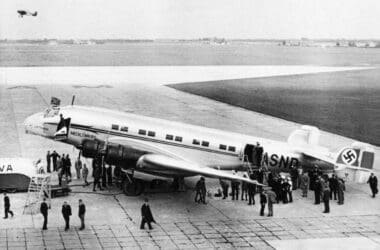 a group of people standing around an airplane