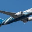 a blue and white airplane in the sky