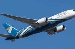 a blue and white airplane in the sky