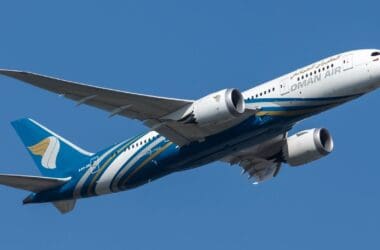 a blue and white airplane in the sky