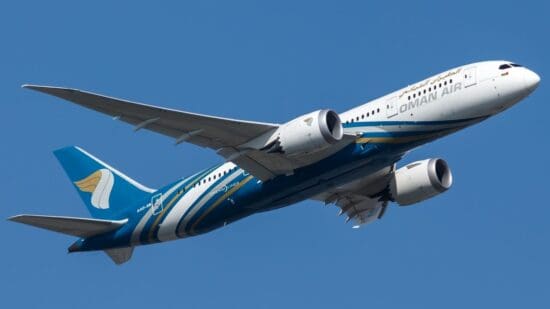 a blue and white airplane in the sky