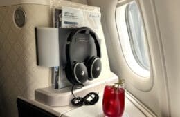 a drink and headphones on a table