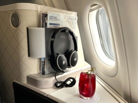 a drink and headphones on a table