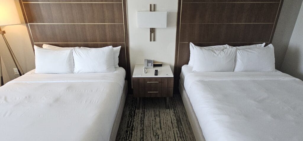 a room with two beds and a telephone on the side table