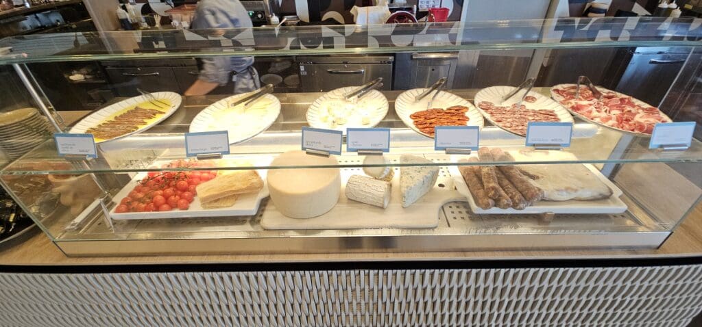 a display case with different types of cheese and meat