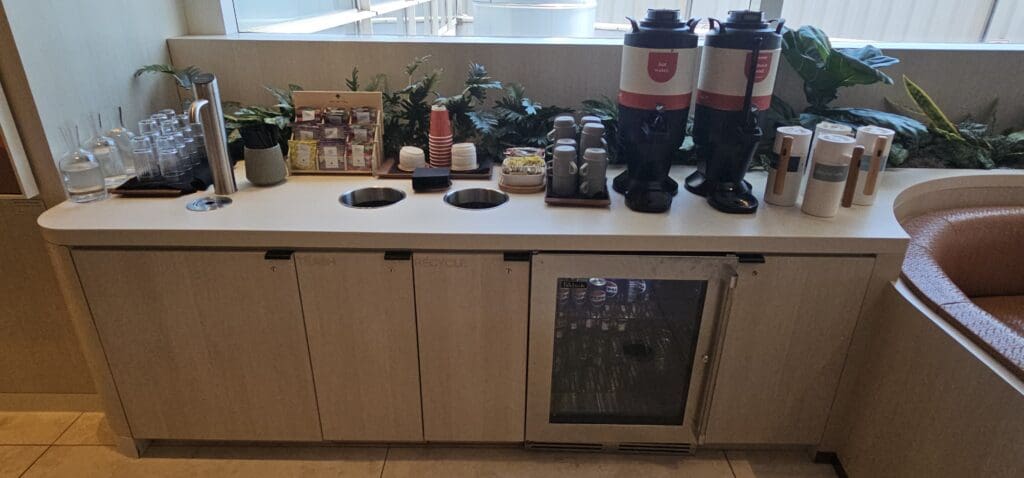 a counter with coffee machines and cups