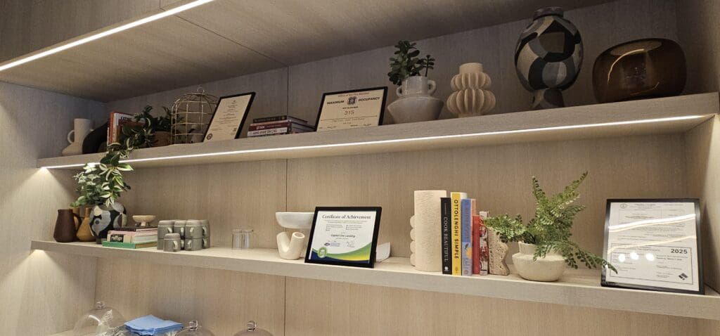 shelves a shelf with books and pictures on it