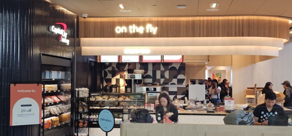 a woman standing at a counter in a restaurant
