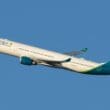 a white and blue airplane in the sky