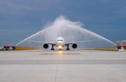 a jet plane spraying water on runway