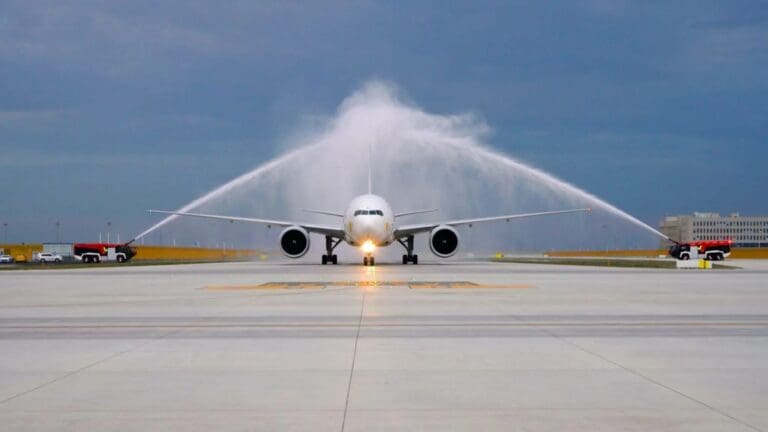 a jet plane spraying water on runway
