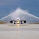 a jet plane spraying water on runway