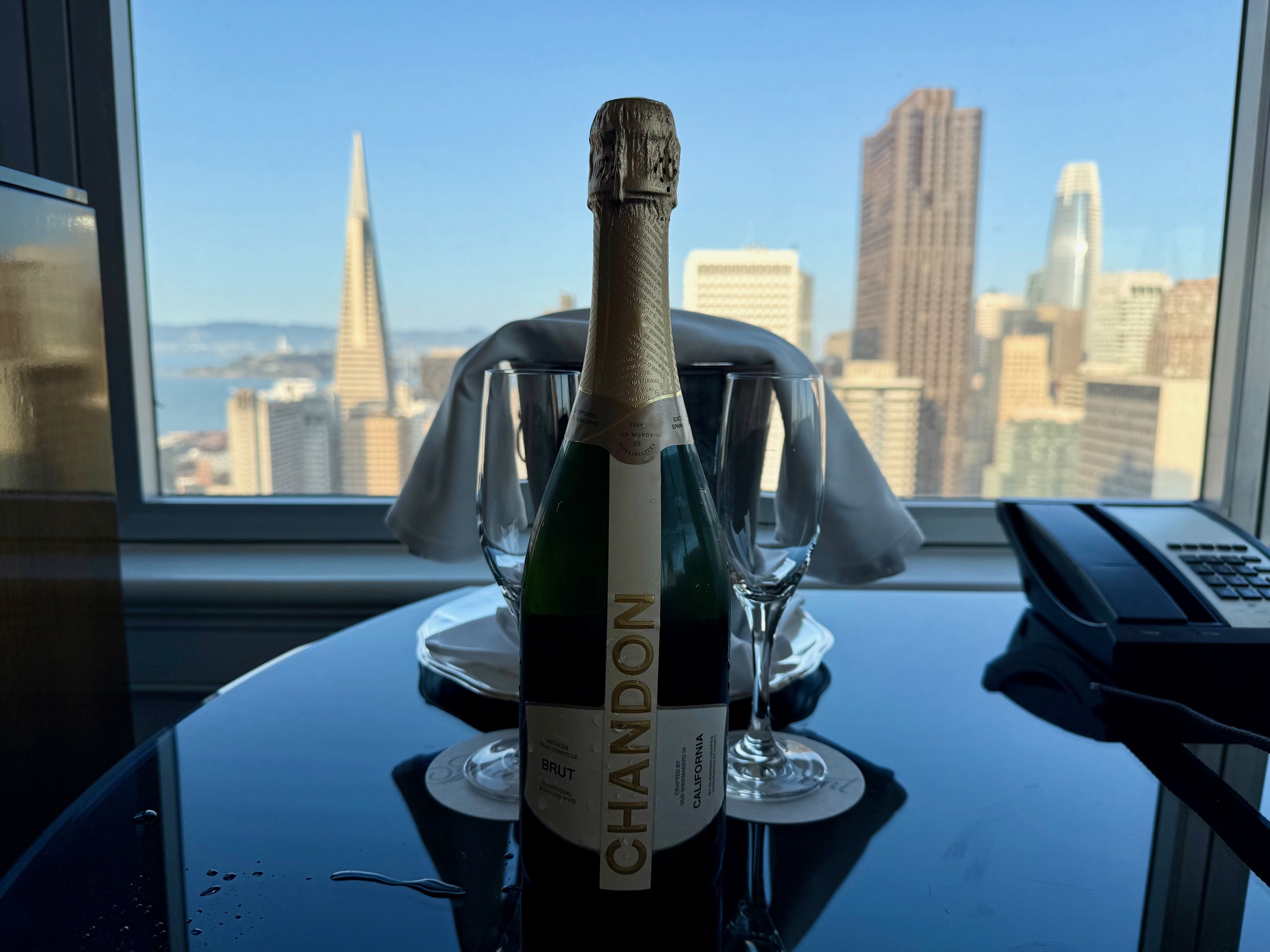 a bottle of champagne and two glasses on a table