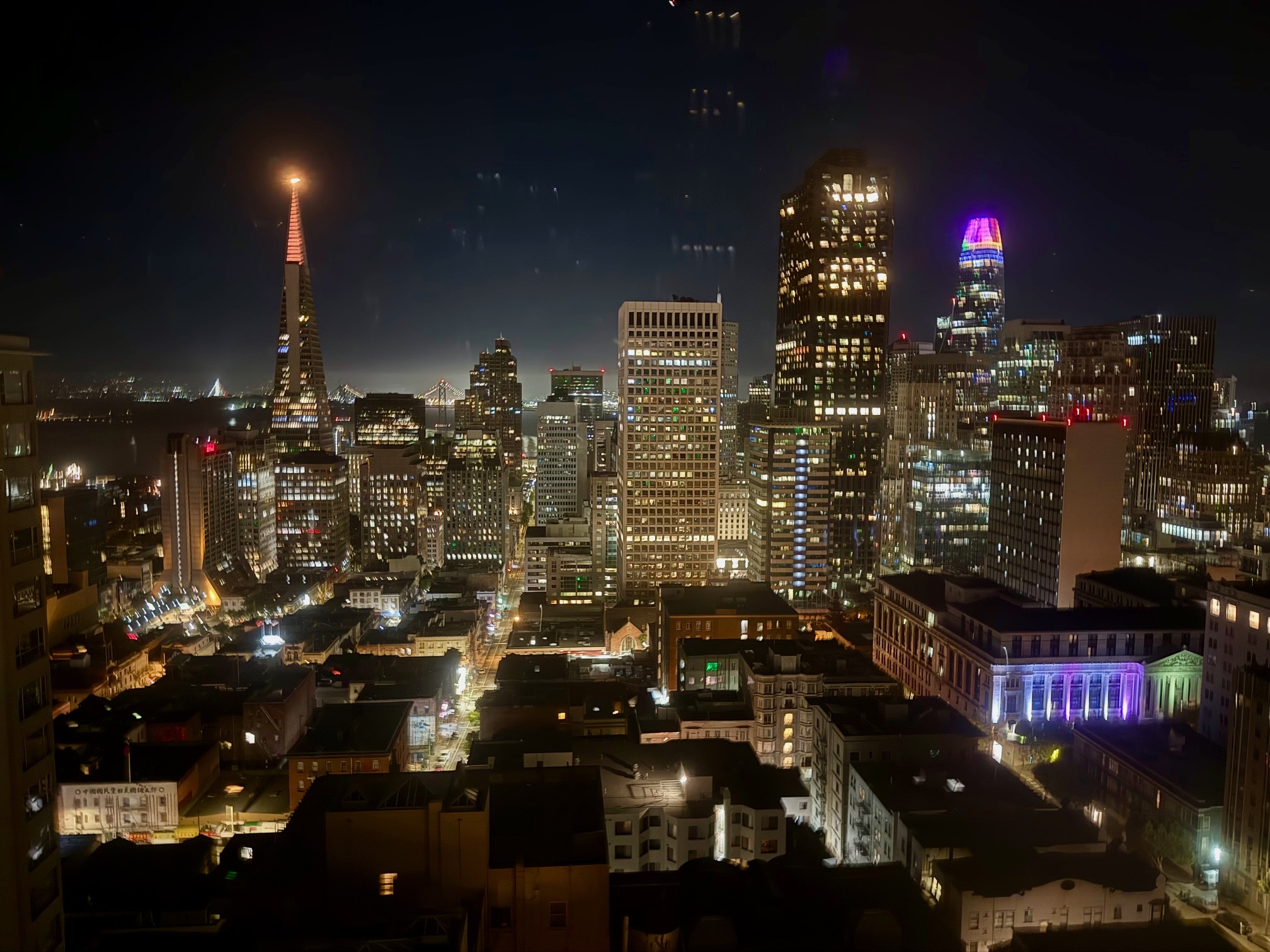 a city at night with many tall buildings