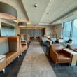 a room with chairs and tables at the American Airlines Admirals Club San Francisco