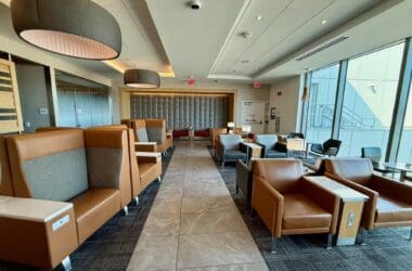 a room with chairs and tables at the American Airlines Admirals Club San Francisco