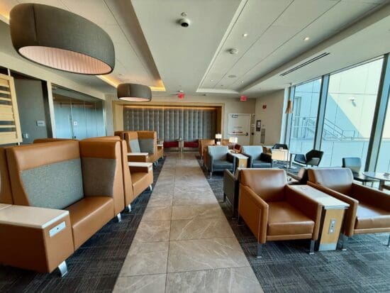 a room with chairs and tables at the American Airlines Admirals Club San Francisco