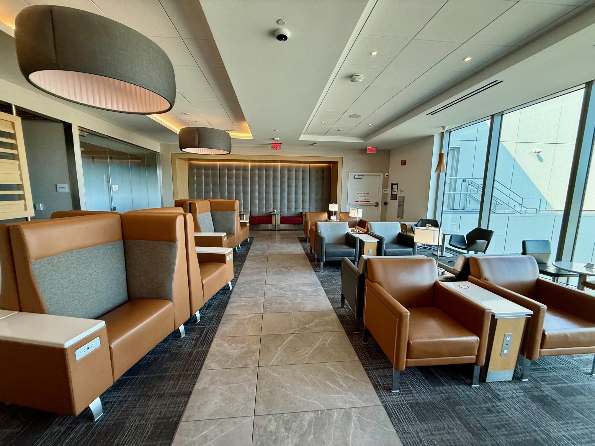 a room with chairs and tables at the American Airlines Admirals Club San Francisco