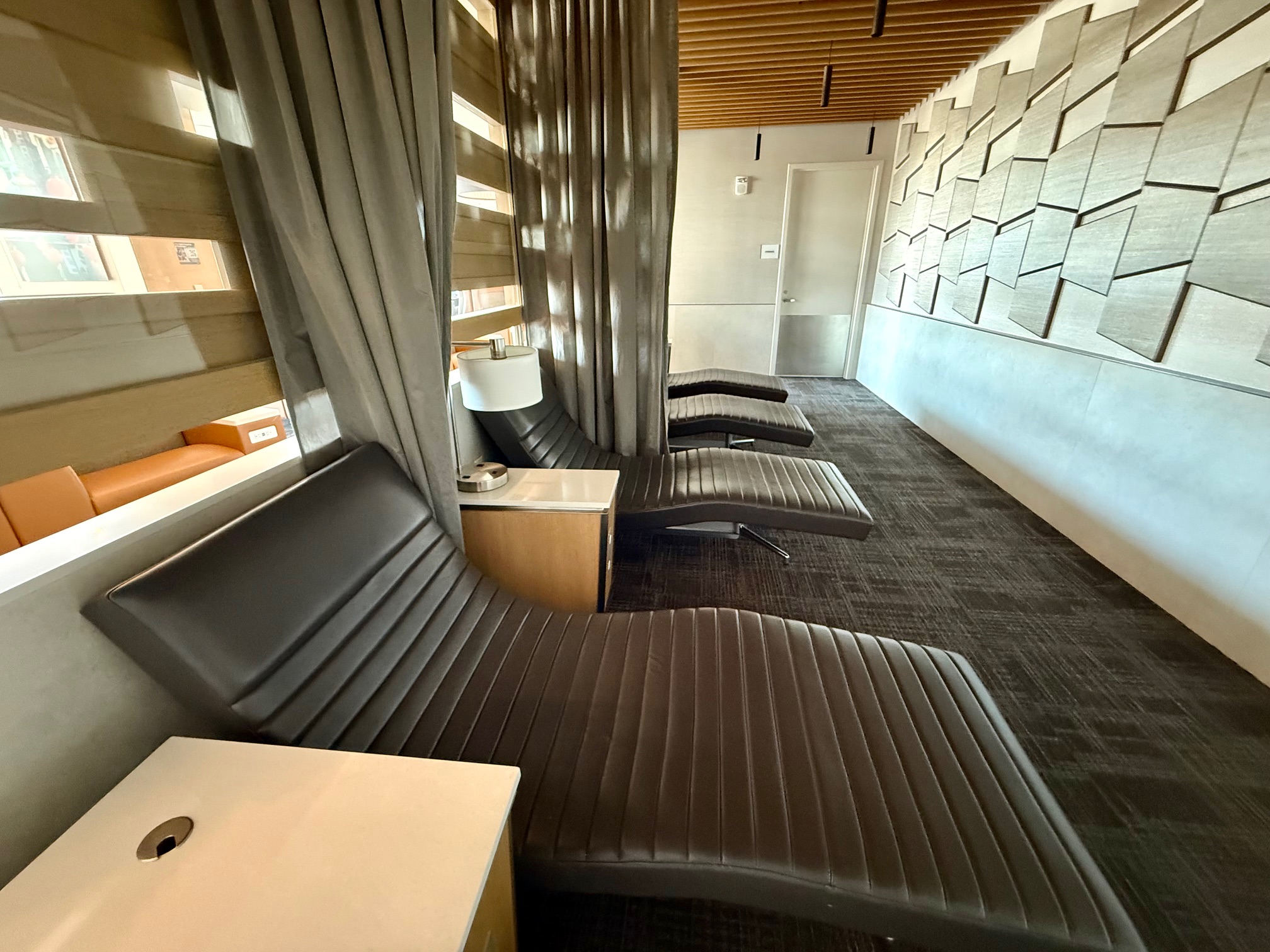 a room with chairs and a desk at the American Airlines Admirals Club San Francisco