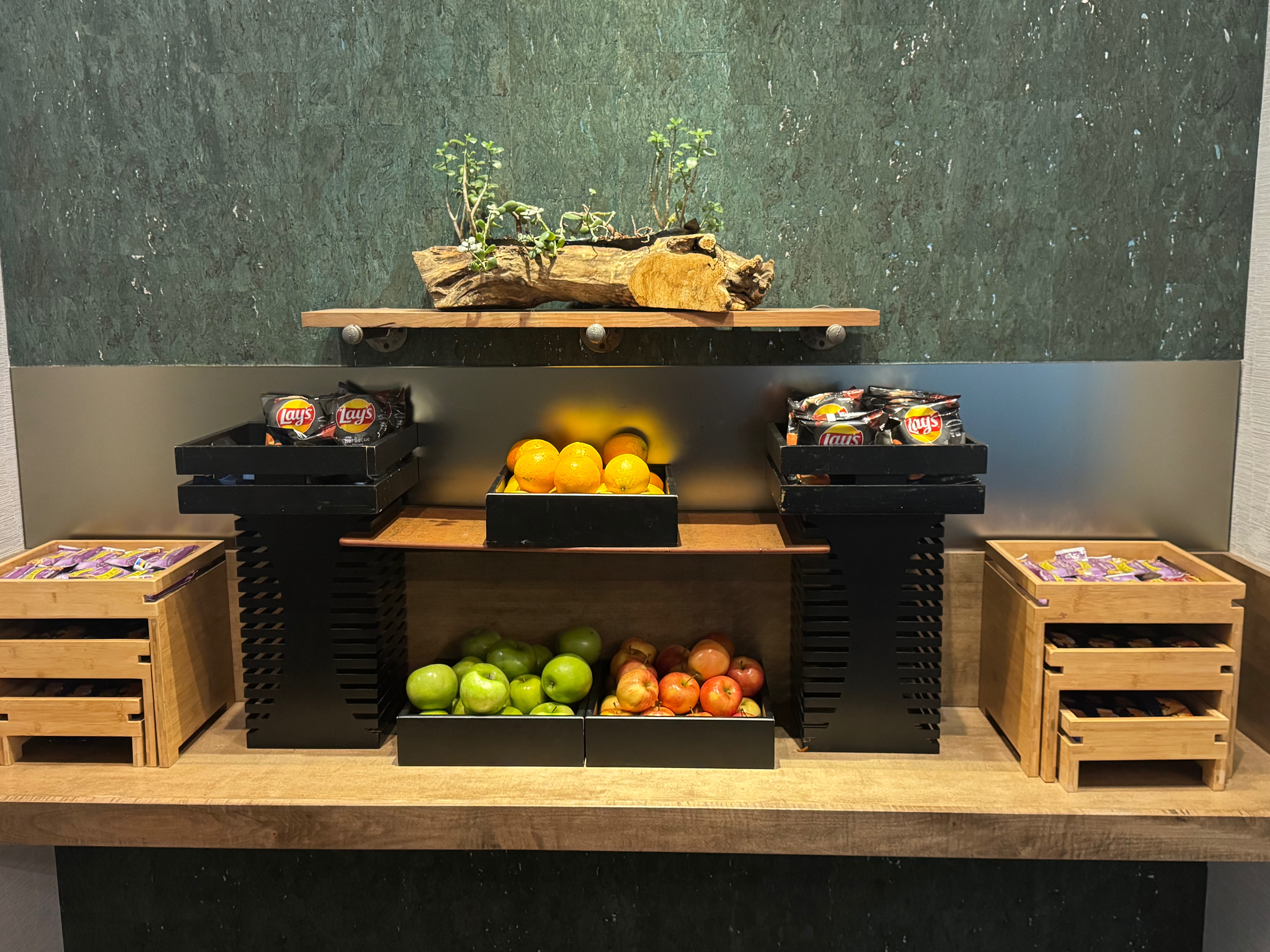 a shelf with fruit and snacks on it