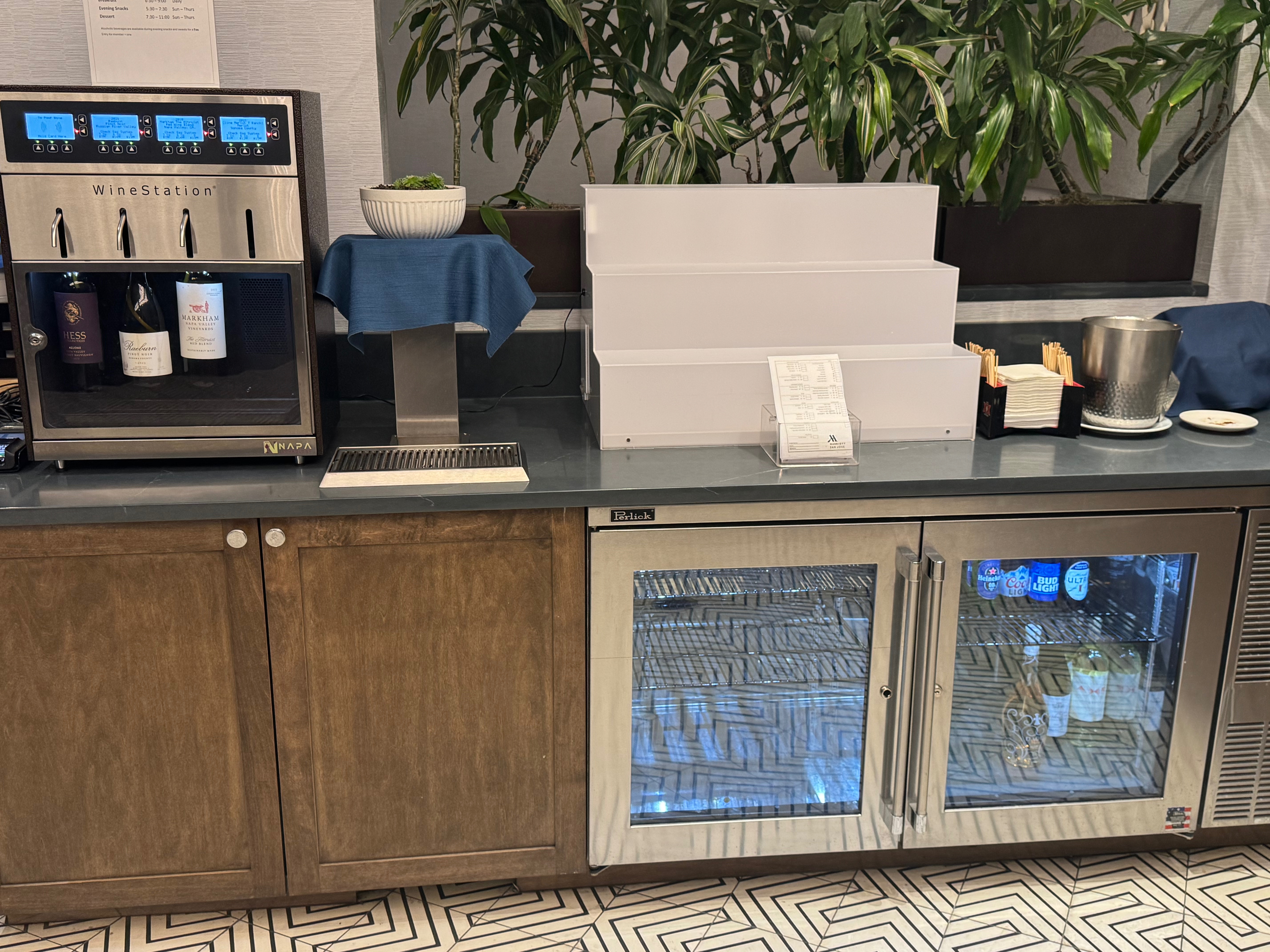 a counter with a refrigerator and a drink dispenser