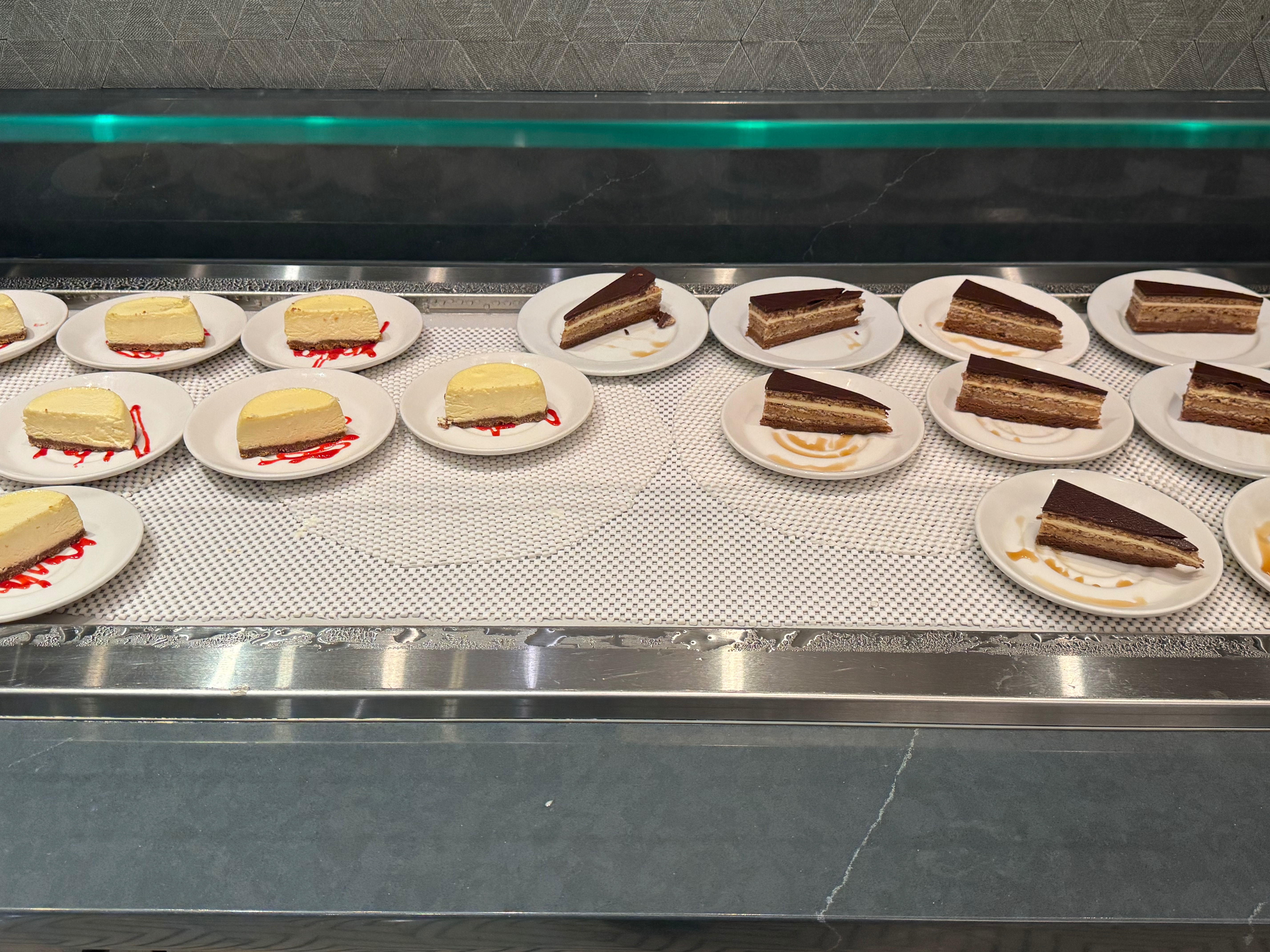 a group of plates of cakes on a counter