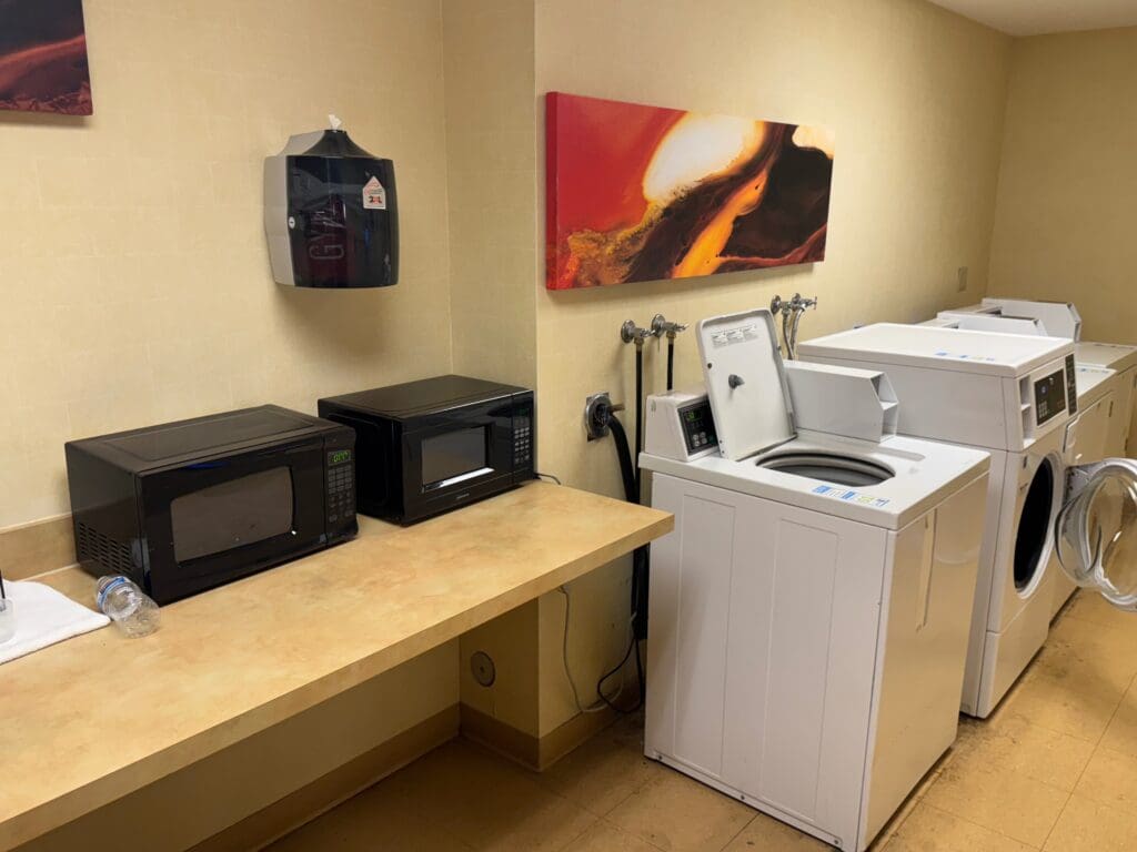a washer dryer and microwaves in a room
