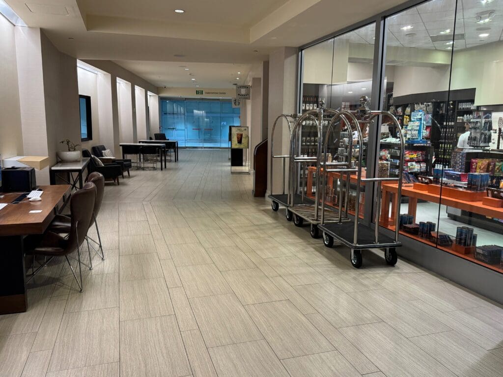 a room with a large glass wall and a trolley