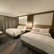 a room with two beds and a table at the Westin Sacramento Riverfront