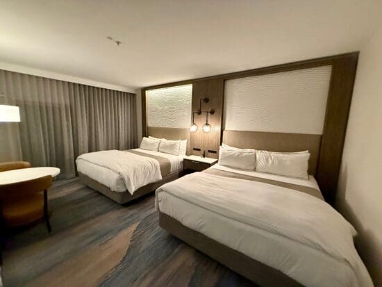 a room with two beds and a table at the Westin Sacramento Riverfront