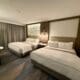 a room with two beds and a table at the Westin Sacramento Riverfront