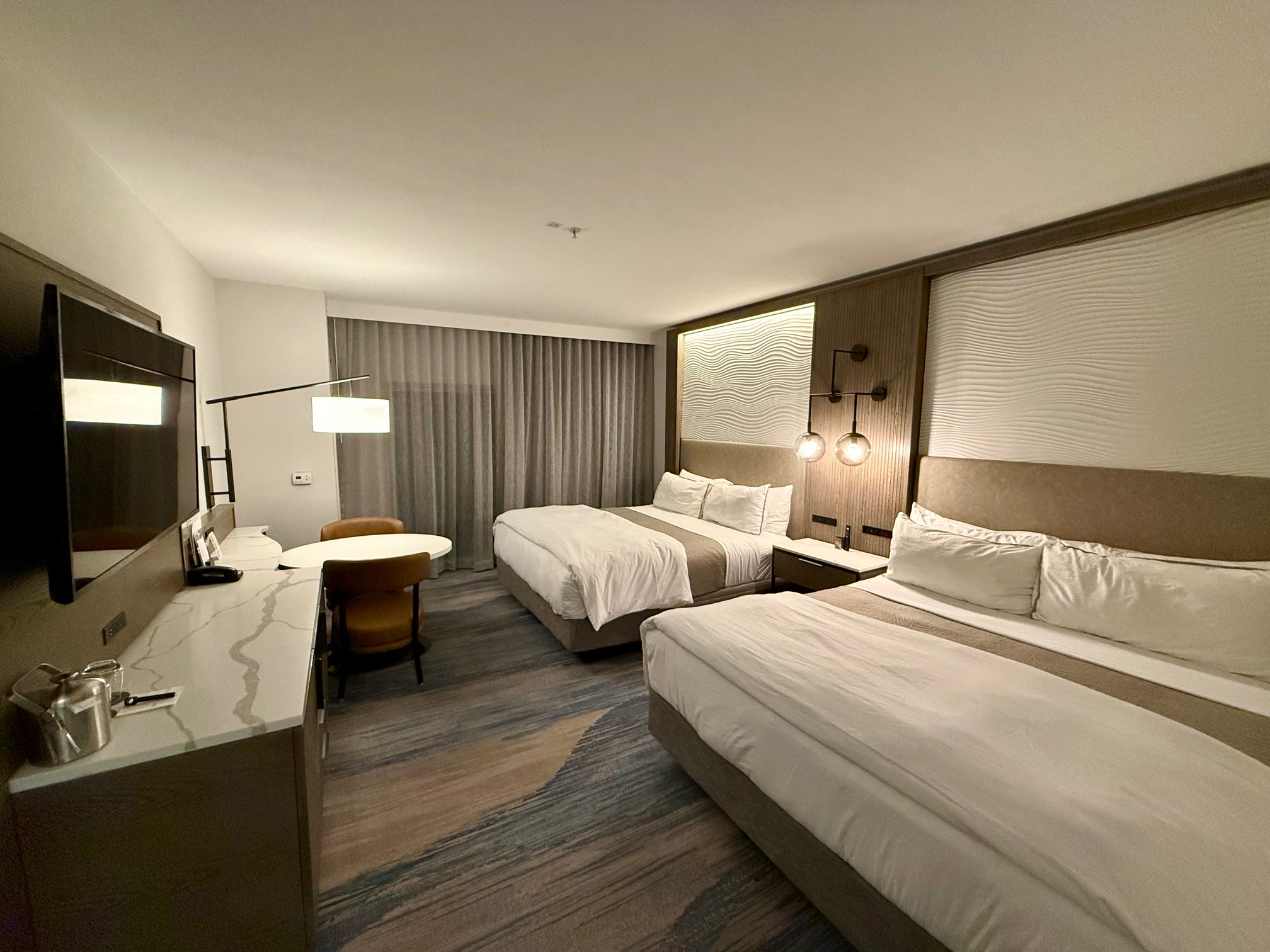 a room with two beds and a desk at the Westin Sacramento Riverfront