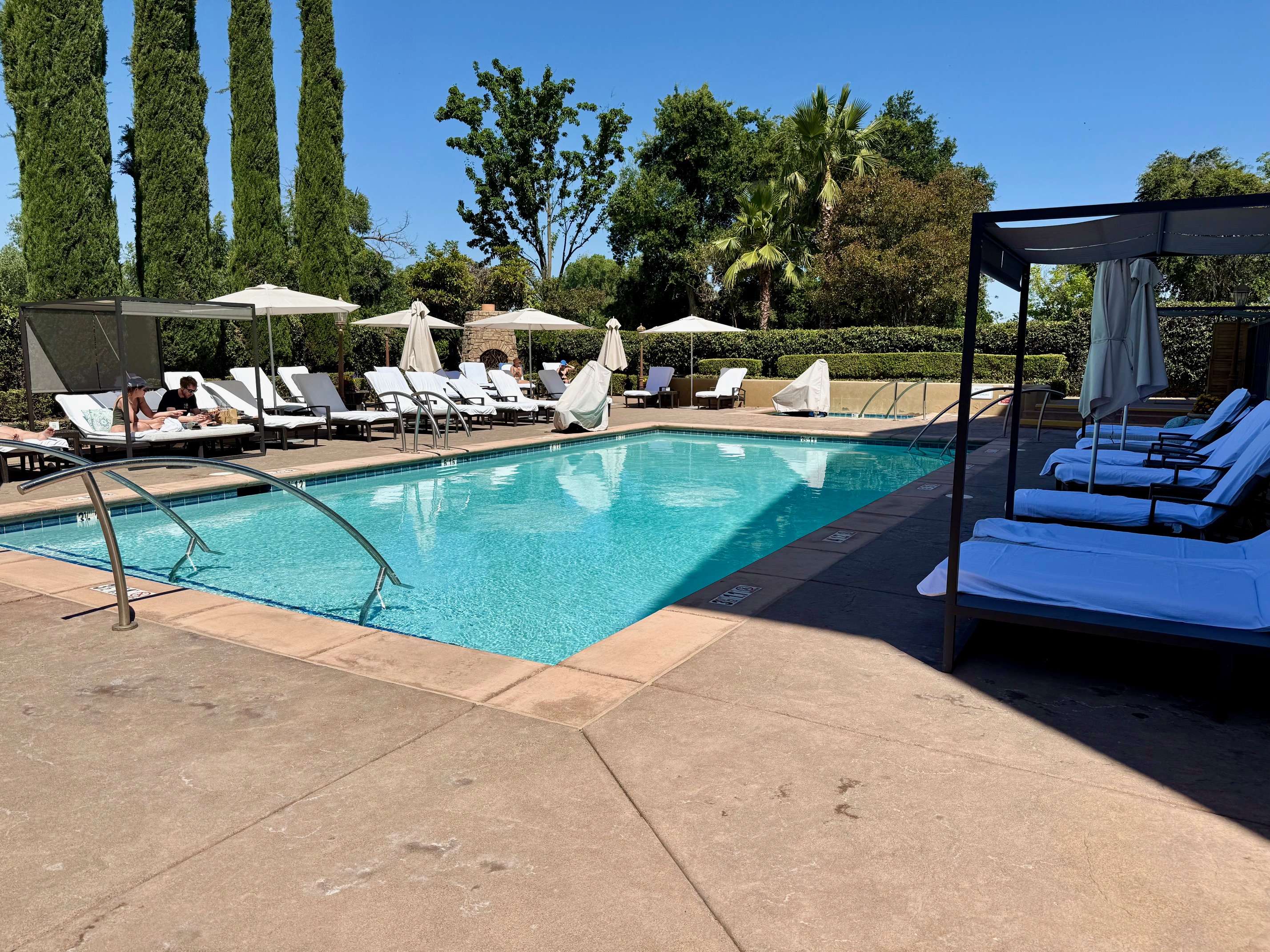a pool with lounge chairs and umbrellas at the Westin Sacramento Riverfront