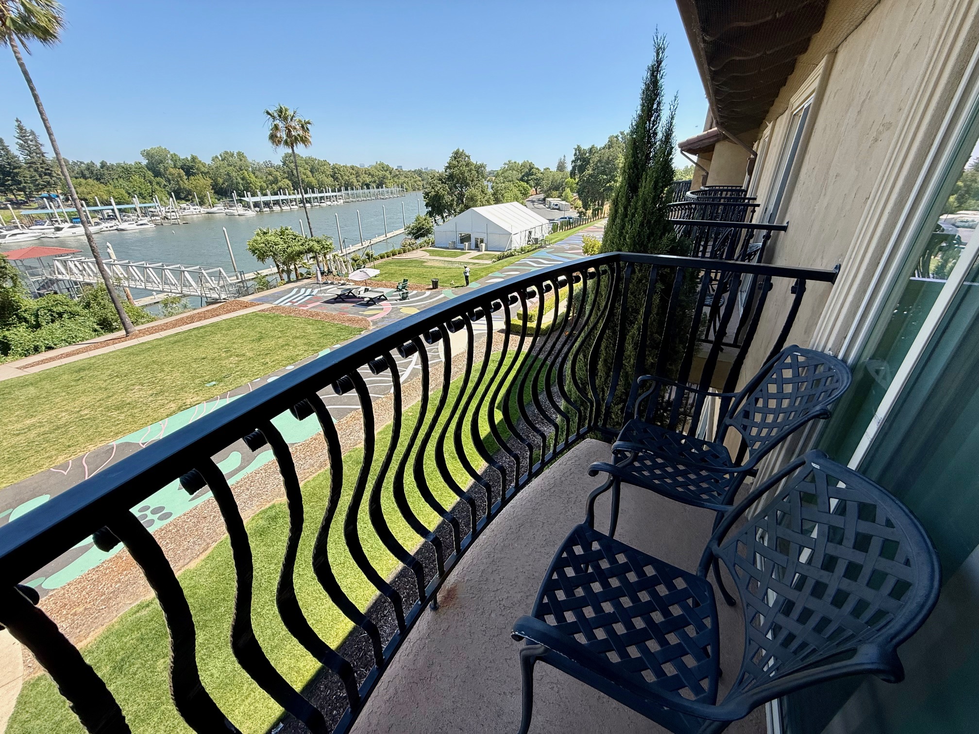 a balcony with chairs and a railing