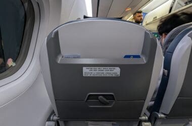 a plane with seats and people in the background