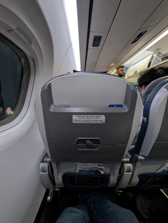 a plane with seats and people in the background