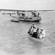 a group of people in a boat on the water