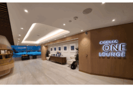 a lobby with a sign and a chair