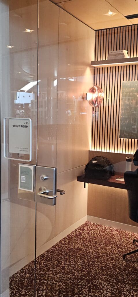 a glass door with a light fixture and a sign on it
