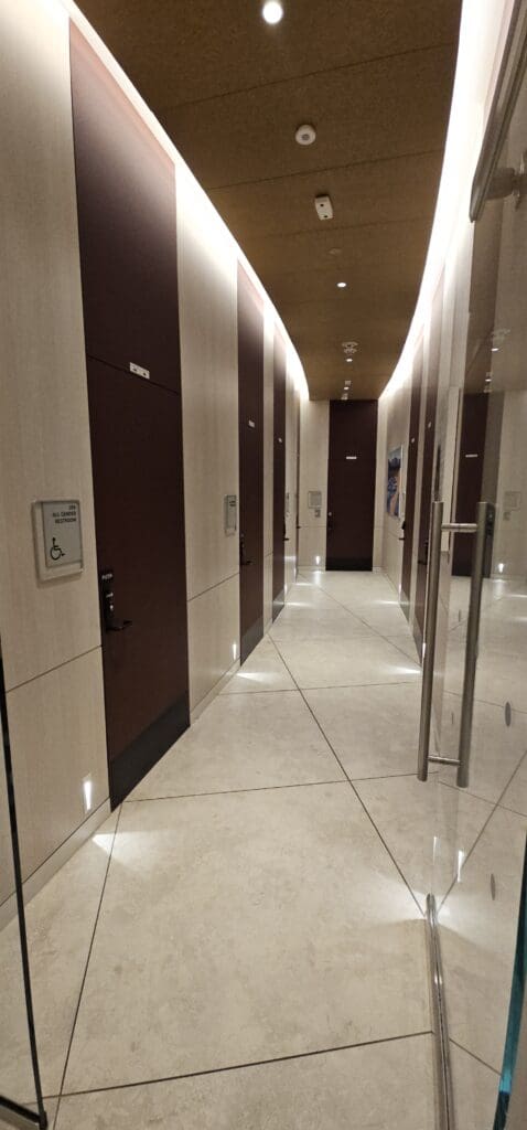 a hallway with doors and a sign