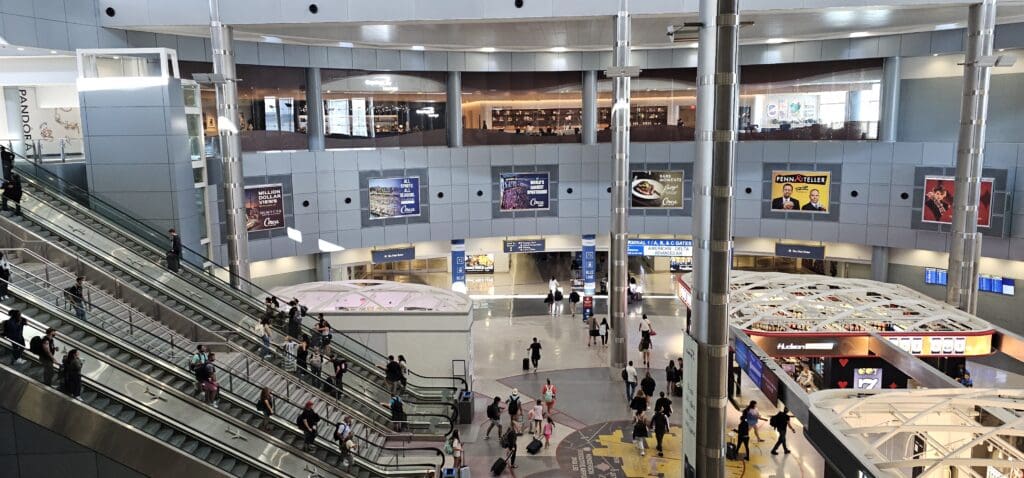 a group of people walking in a large airport