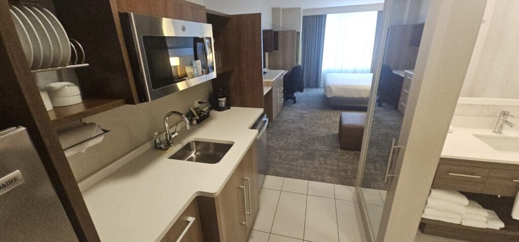 a kitchen with a microwave and a bed