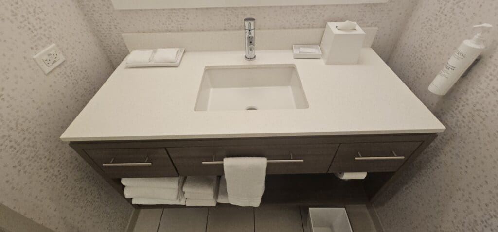 a bathroom sink with a towel on the counter
