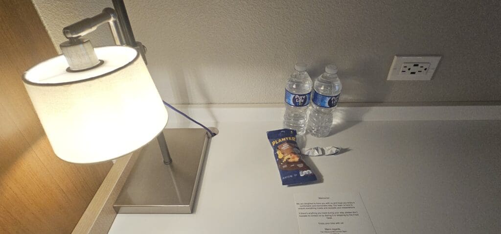 a table with water bottles and a bag of chips