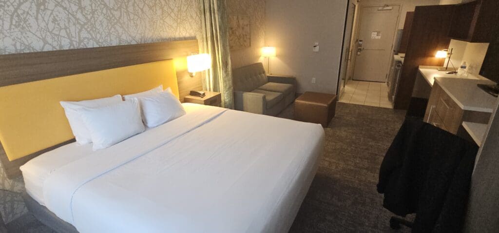 a hotel room with a bed and couches